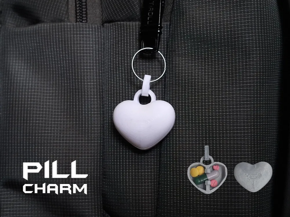 Heart-shaped charm attached to a dark bag, with smaller open-heart views beside it